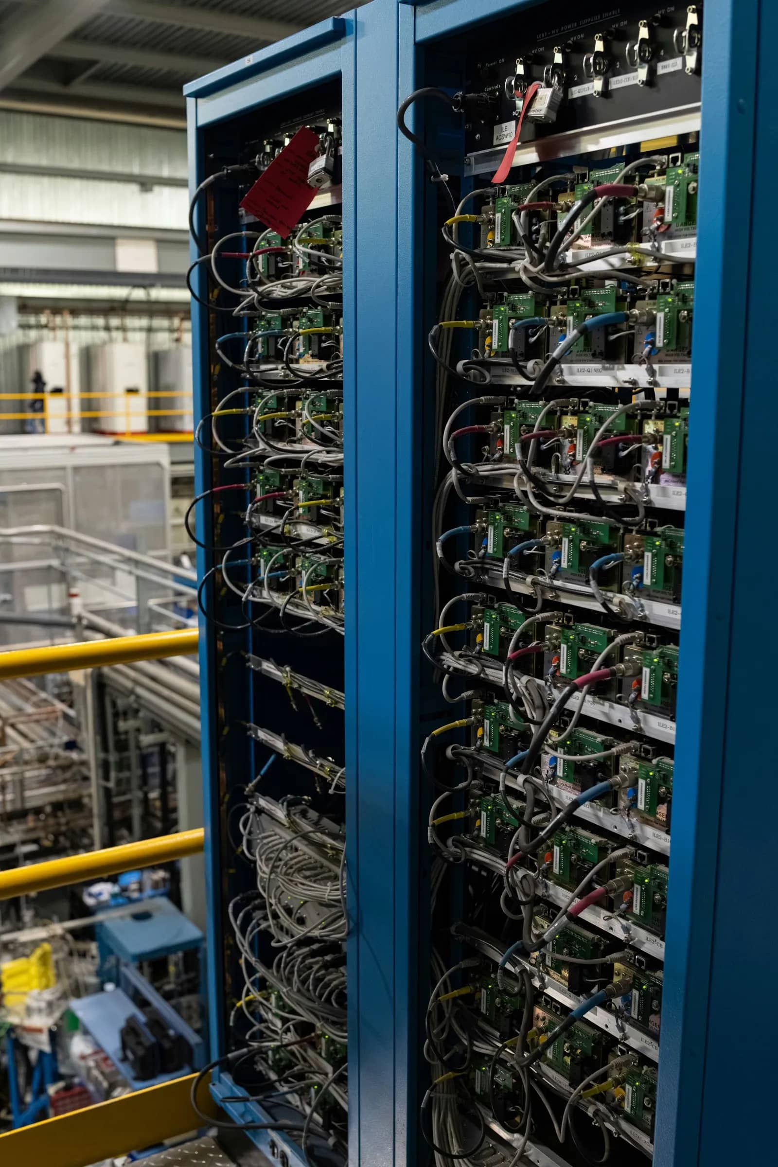 Open data centre racks with dense multi-coloured network cabling and circuit boards
