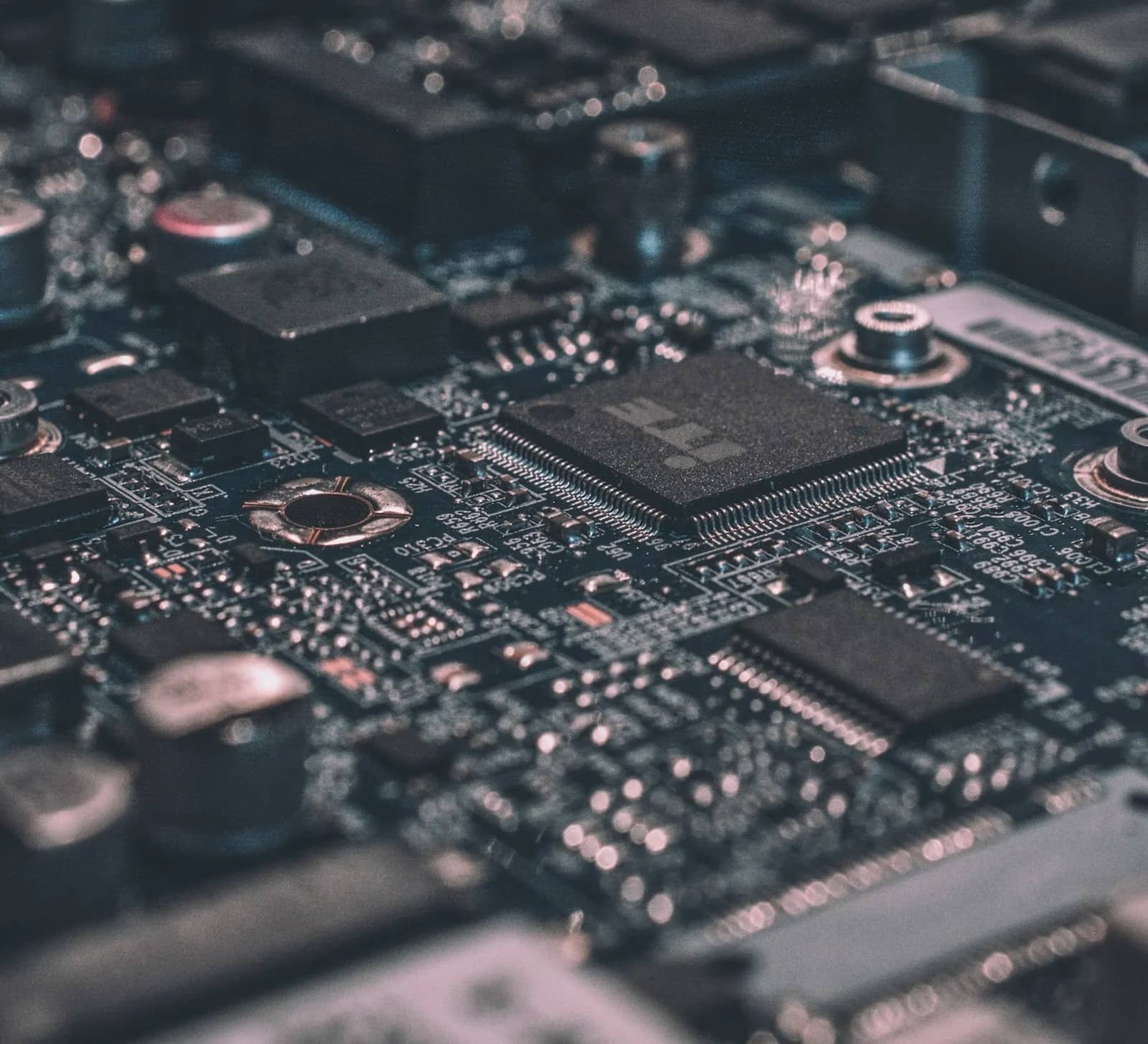 Close-up of circuit board components and copper traces on dark IT hardware